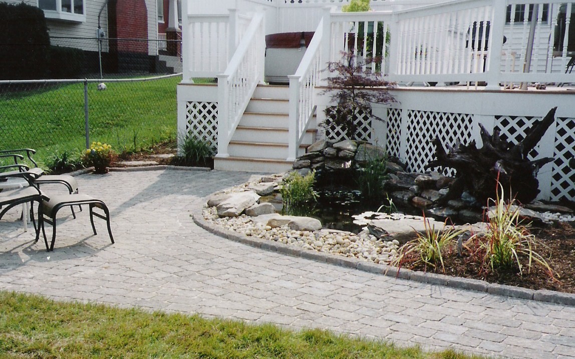 The deck stairs, sitting area, and pond