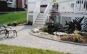 The deck stairs, sitting area, and pond